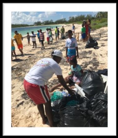 People cleaning trash from beach in Bahamas
